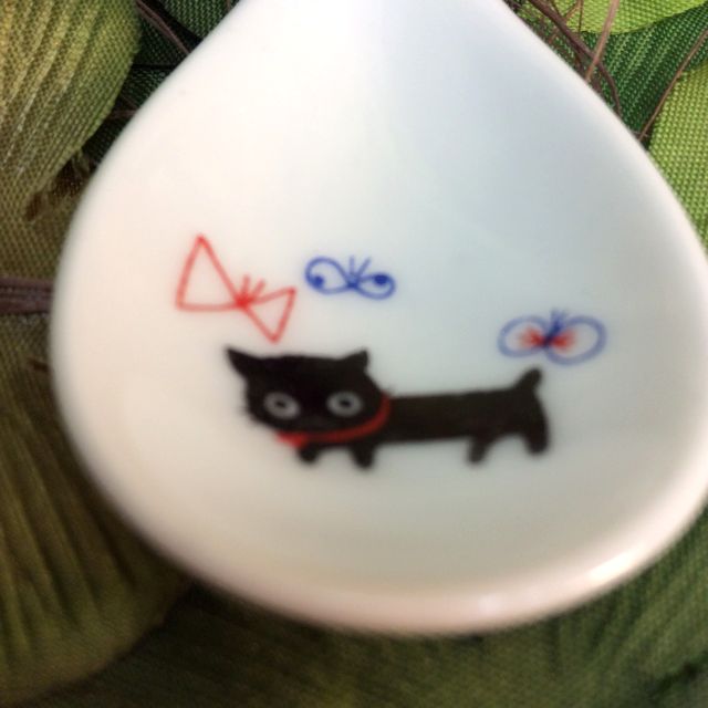 カトウシンジ黒猫ティースプーンの赤いリボンを首にむすんだ黒猫と赤と青の蝶のスプーンのクローズアップ画像