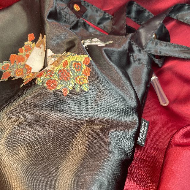 猫のマンハッタナーズ折りたたみ傘とバッグのセット「天使の祝福」柄のバッグのロゴマークの画像